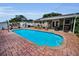 Inviting in-ground pool and covered patio offer a perfect setting for relaxation and outdoor living at 11236 116Th St, Largo, FL 33778