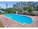 Refreshing in-ground pool with brick surround, perfect for relaxing and entertaining guests at 11236 116Th St, Largo, FL 33778