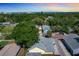 An aerial view of a neighborhood showcases lush green trees and houses near a beautiful ocean at 1137 Highland S St, St Petersburg, FL 33701