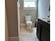 An updated bathroom featuring modern vanity with sliding doors, toilet, and tiled floors at 1137 Highland S St, St Petersburg, FL 33701