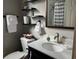 Well-appointed bathroom with a white vanity, floating shelves, and a shower with a curtain at 1137 Highland S St, St Petersburg, FL 33701