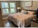 Cozy bedroom with hardwood floors, large windows, and a comfortable queen-size bed at 1137 Highland S St, St Petersburg, FL 33701