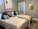 Cozy bedroom with two twin beds, soft bedding, and stylish decor for a relaxing atmosphere at 1137 Highland S St, St Petersburg, FL 33701