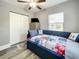 Cozy bedroom featuring a colorful quilt, ceiling fan, closet, and natural light from the window at 1137 Highland S St, St Petersburg, FL 33701