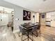 Elegant dining area with a dark wood table, seating for six, modern decor, and access to the kitchen at 1137 Highland S St, St Petersburg, FL 33701