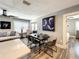 Well-lit dining area featuring a dark wood table, seating for six, contemporary decor, and a view into the living space at 1137 Highland S St, St Petersburg, FL 33701