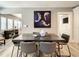 Dining room with modern table, six chairs, a stylish painting, and hardwood floors at 1137 Highland S St, St Petersburg, FL 33701
