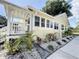 Charming yellow home with a welcoming porch and beautifully landscaped front yard, perfect for curb appeal at 1137 Highland S St, St Petersburg, FL 33701