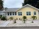 Charming yellow bungalow with a well-maintained front yard and white gravel landscaping at 1137 Highland S St, St Petersburg, FL 33701