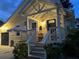 Charming home exterior with inviting front porch with outdoor seating and striped awning at 1137 Highland S St, St Petersburg, FL 33701