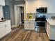 Bright kitchen with white cabinets, stainless steel appliances, and neutral backsplash at 1137 Highland S St, St Petersburg, FL 33701