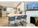Kitchen boasts white cabinetry, stainless appliances, a quartz countertop island, and a decorative painted brick fireplace at 1137 Highland S St, St Petersburg, FL 33701