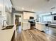 Modern kitchen featuring white cabinets, a stainless steel range, a breakfast bar, and an open view to the living room at 1137 Highland S St, St Petersburg, FL 33701