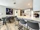 Bright kitchen featuring a white island, modern bar stools, updated cabinets, and a dining table with seating for six at 1137 Highland S St, St Petersburg, FL 33701