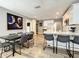 Open-concept kitchen with white cabinets, gray walls, stainless appliances, and an adjacent dining area with modern decor at 1137 Highland S St, St Petersburg, FL 33701