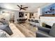 Open-concept living room with hardwood floors, a kitchen bar, and modern furnishings, ideal for entertaining at 1137 Highland S St, St Petersburg, FL 33701