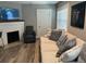 Cozy living room features a brick fireplace, plush sofa, and a wall-mounted television at 1137 Highland S St, St Petersburg, FL 33701