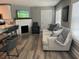 Comfortable living room boasts a sofa, chair, fireplace, and open layout to kitchen area at 1137 Highland S St, St Petersburg, FL 33701