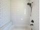 Shower featuring white subway tile surround with bronze fixtures and built-in seat at 1137 Highland S St, St Petersburg, FL 33701