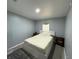 Bedroom with gray walls, light-colored carpeting and simple furnishings at 12319 Memorial Hwy, Tampa, FL 33635