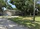 Modest home with lawn and driveway under a shady tree canopy at 12319 Memorial Hwy, Tampa, FL 33635