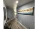 Hallway featuring wood floors and a decorative painting with an open view to the kitchen at 12319 Memorial Hwy, Tampa, FL 33635
