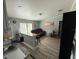 Living room featuring a comfortable brown couch, small bar and decorative artwork at 12319 Memorial Hwy, Tampa, FL 33635