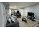 Open concept living room with sofa, coffee table, and kitchen in the background at 12319 Memorial Hwy, Tampa, FL 33635