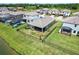 Aerial view of a home and backyard with a fenced perimeter, screened porch, and lake nearby at 12646 Oak Hill Way, Parrish, FL 34219