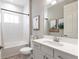 Bathroom with tub, shower, white vanity, framed artwork, and decorative elements at 12646 Oak Hill Way, Parrish, FL 34219