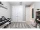 Bedroom featuring a piano, a storage unit with decor, and a double door closet at 12646 Oak Hill Way, Parrish, FL 34219