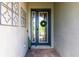 Elegant front door with glass panels and a decorative wreath at 12646 Oak Hill Way, Parrish, FL 34219