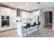Kitchen featuring an island, stainless steel appliances, and white cabinets at 12646 Oak Hill Way, Parrish, FL 34219