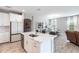 Open concept kitchen with a breakfast bar, white cabinets, and stainless steel appliances at 12646 Oak Hill Way, Parrish, FL 34219