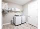 Well-organized laundry room with washer, dryer, storage shelf, and tile flooring at 12646 Oak Hill Way, Parrish, FL 34219
