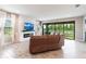 Cozy living room with a fireplace, and sliding doors to the outside at 12646 Oak Hill Way, Parrish, FL 34219