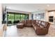 Inviting living room featuring a large sectional sofa and sliding glass doors to the screened patio at 12646 Oak Hill Way, Parrish, FL 34219