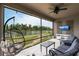 Screened lanai featuring comfortable seating, hanging chair, and view of the backyard pond at 12646 Oak Hill Way, Parrish, FL 34219