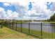 Scenic view of a community pond with a fountain, surrounded by well-maintained lawns at 12646 Oak Hill Way, Parrish, FL 34219