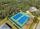 An aerial view highlights the community's well-maintained tennis courts at 13747 Forest Ridge Ct, Hudson, FL 34667