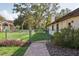 Fenced backyard with lush lawn and garden beds, offering privacy and security for outdoor activities and gardening at 13747 Forest Ridge Ct, Hudson, FL 34667
