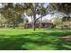 Expansive backyard with lush green lawn and a screened-in lanai, providing a private outdoor retreat and relaxation area at 13747 Forest Ridge Ct, Hudson, FL 34667