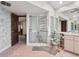 Bathroom with accessible shower, textured wallpaper and ample space at 13747 Forest Ridge Ct, Hudson, FL 34667