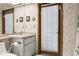 Well-lit bathroom featuring a vanity, mirror, and access to an enclosed shower area at 13747 Forest Ridge Ct, Hudson, FL 34667
