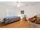 Bright bedroom with hardwood floors and a ceiling fan for added comfort at 13747 Forest Ridge Ct, Hudson, FL 34667