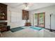 Bonus room features light-colored tile floors, built-in shelves, and French door access to the yard at 13747 Forest Ridge Ct, Hudson, FL 34667