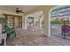 Expansive covered patio with brick pavers, showcasing an outdoor kitchen and access to a screened pool area at 13747 Forest Ridge Ct, Hudson, FL 34667