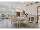 Bright dining area with tile floors, white furniture, and abundant natural light from large windows at 13747 Forest Ridge Ct, Hudson, FL 34667