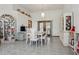 Formal dining area with white table and chairs, tile flooring, and bright lighting at 13747 Forest Ridge Ct, Hudson, FL 34667