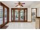 Dining room featuring French doors leading to the outdoor patio and ample lighting at 13747 Forest Ridge Ct, Hudson, FL 34667